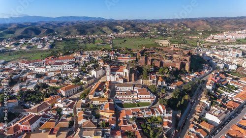 Fototapeta Naklejka Na Ścianę i Meble -  The Portuguese historic village of Silves, Algarve zone, view from the sky, aerial. Fortress and church in the foreground. Portimao
