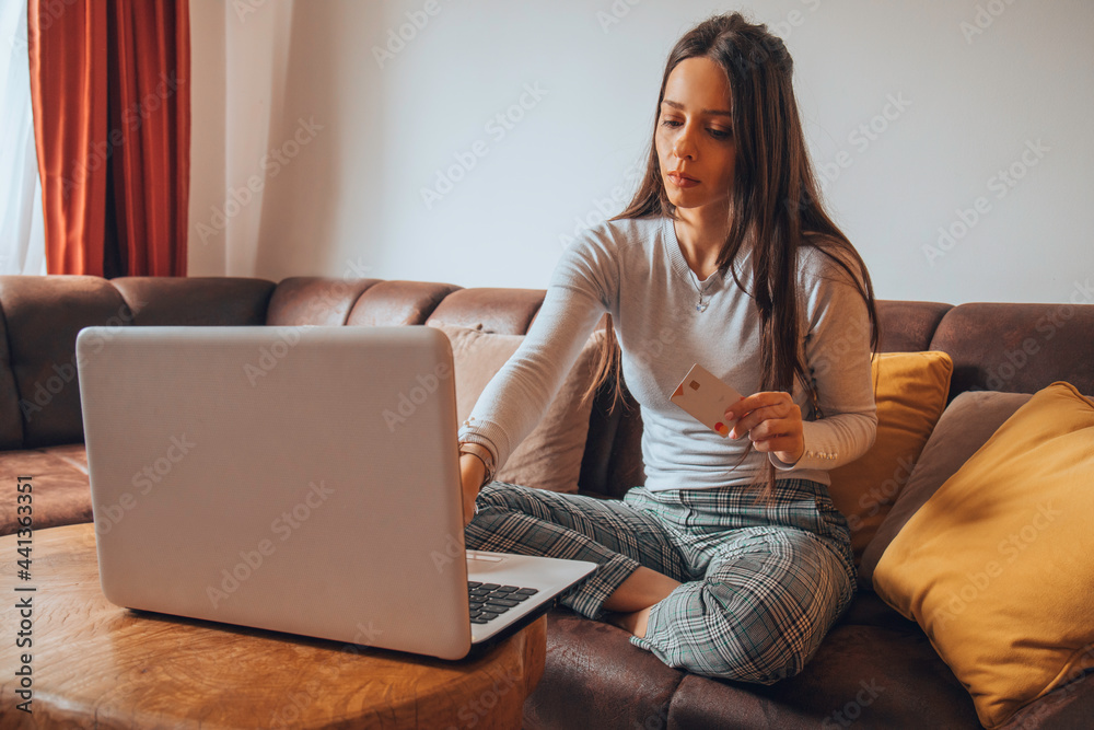 Woman holding credit card and shopping online. Woman holding credit card and shopping online.