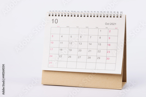 Page with dates of october is open on desk calendar closeup