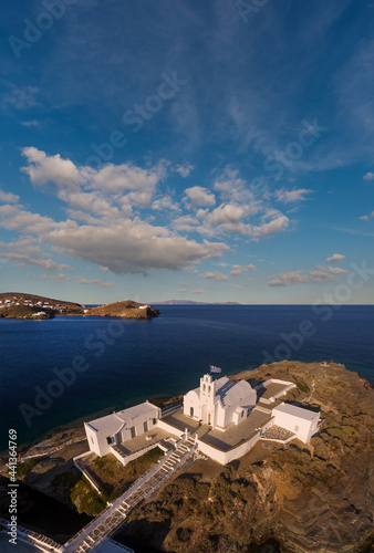 The famous Chrisopigi Monastery above a rocky peninsula on the southeast coast of the Greek island of Sifnos in the Cyclades archipelago photo