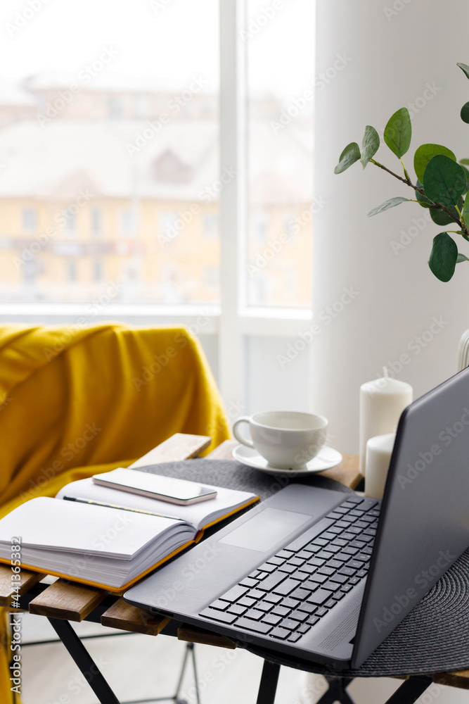 Fototapeta premium black laptop keyboard on white window background. Distant work. Online training. Home office