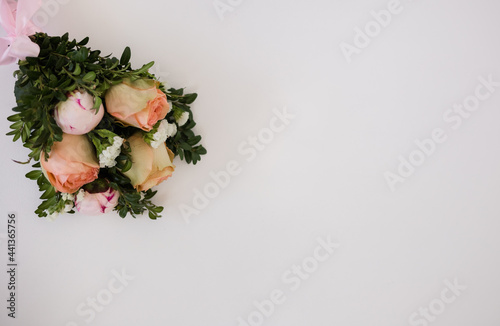 a bouquet of fresh flowers on a white background with a place for text. Wedding bouquet with roses photo