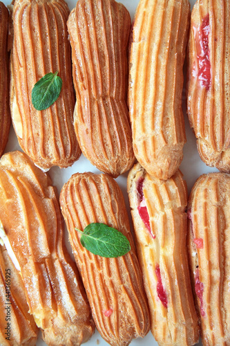 Delicious eclairs with custard, сloseup dessert in flat lay style. Food concept, top view.