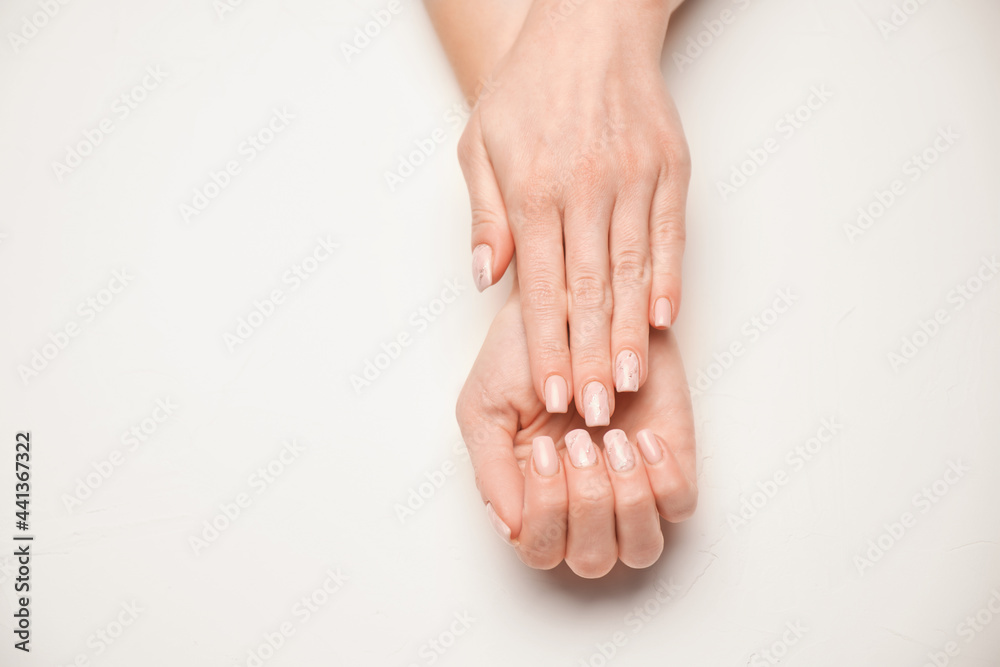 Woman hands with beautiful manicure on light background Woman hands with beautiful manicure on light background