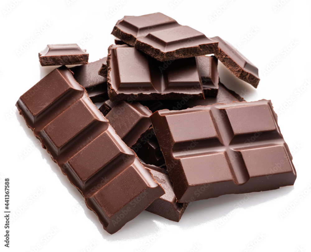 Pieces of dark chocolate bar isolated on white background. Sweet food is made of cocoa and sugar. Pieces of dark chocolate bar isolated on white background. Sweet food is made of cocoa and sugar.