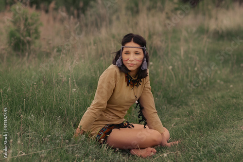 Canvastavla Indian squaw sitting on the grass
