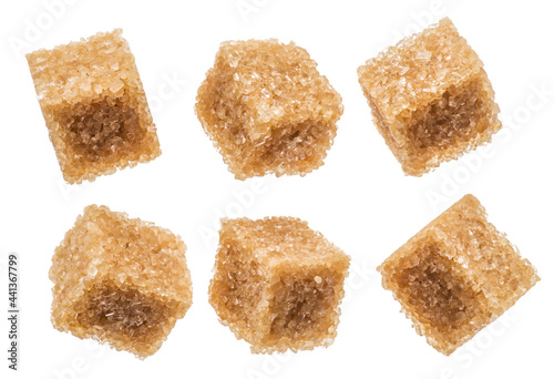 Brown sugar cubes on white background. Macro picture.