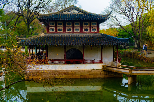 Ancient pavilion chinese architecture building in Suzhou park with white and red walls, good place for trip