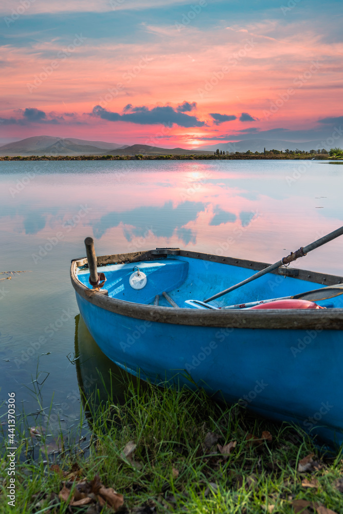 Old rustic boat on a lakeside during sunset with Langeberg mountain in the background