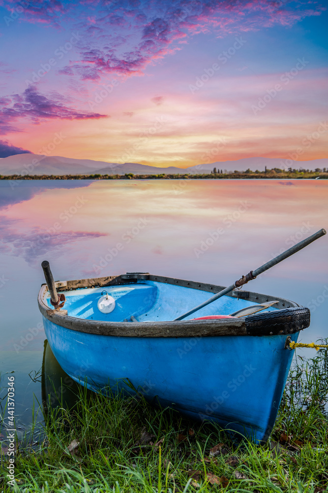 Old rustic boat on a lakeside during sunset with Langeberg mountain in the background
