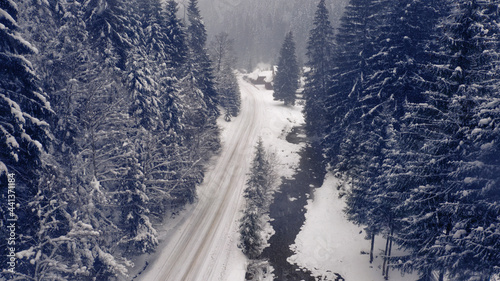 Mountain road forest winter view from drone