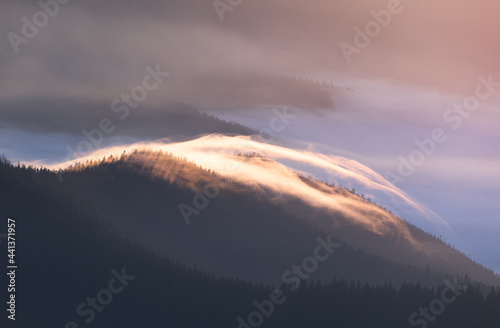 Fog on top of the mountain at dawn.
