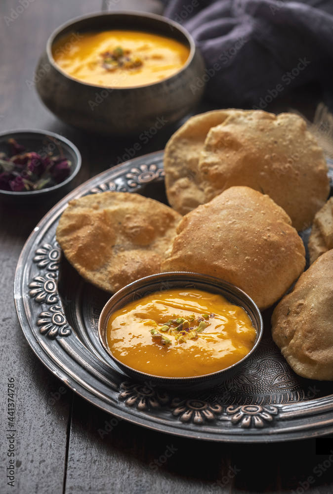 Aam Ras Puri or Alphonso Mango pulp with fried Poori Aam Ras Puri or Alphonso Mango pulp with fried Poori