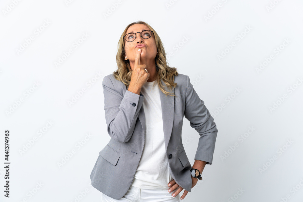 Middle aged business woman over isolated white background having doubts while looking up Middle aged business woman over isolated white background having doubts while looking up