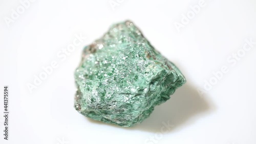 natural fuchsite rough gemstone on the background