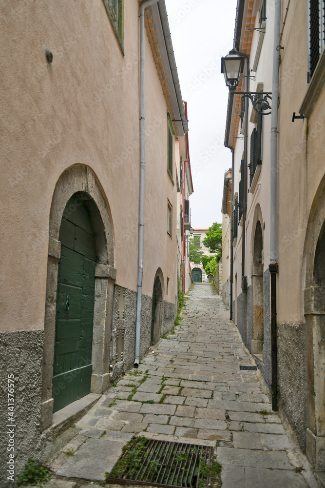 A small street between the old houses of Agnone, a medieval village in the mountains of the Molise region, Italy.