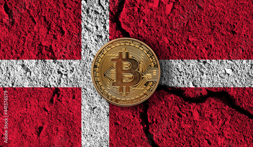 Bitcoin crypto currency coin with cracked Denmark flag. Crypto restrictions