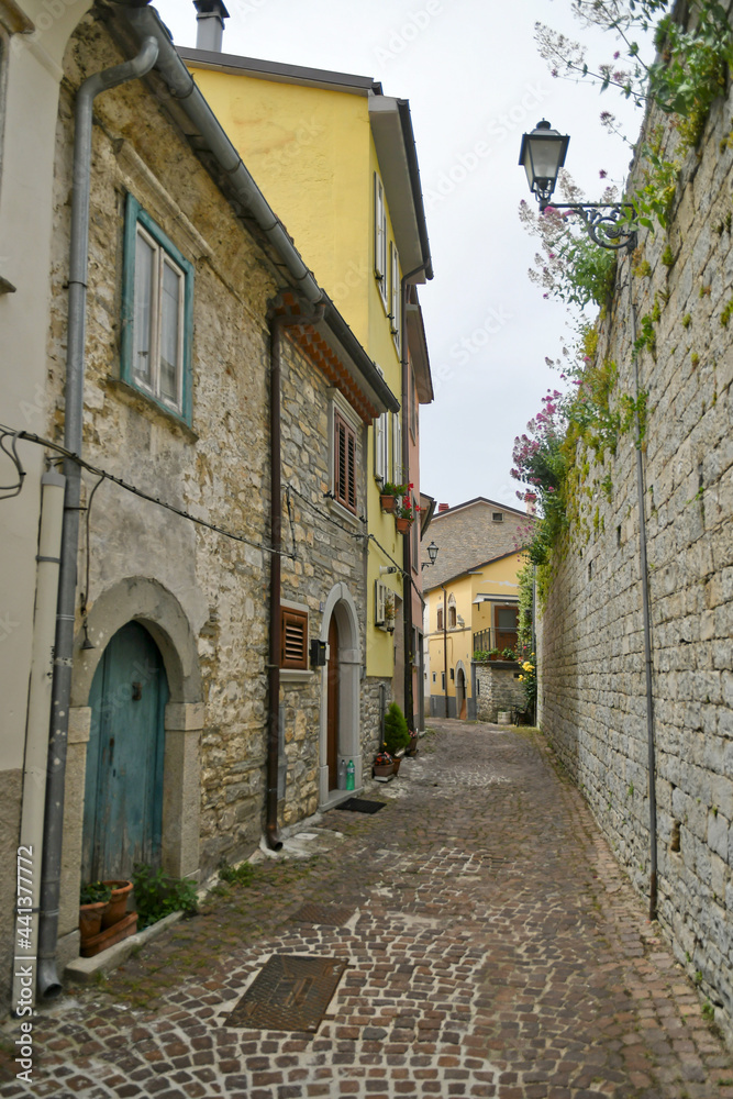 A small street between the old houses of Agnone, a medieval village in the mountains of the Molise region, Italy.