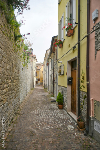 Fototapeta Naklejka Na Ścianę i Meble -  A small street between the old houses of Agnone, a medieval village in the Molise region in Italy.