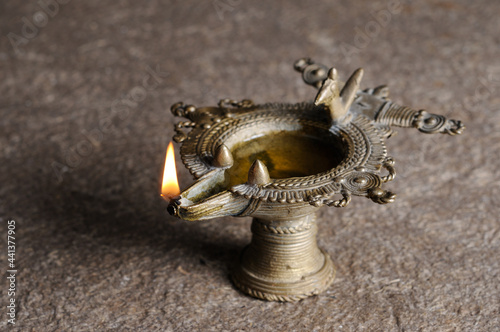 Indian traditional Samai or Samayee, a typical shape of diya (lamp) usually made up of brass, lit using cotton thread dipped in oil where we worship god at home or temple Holy Pooja. photo