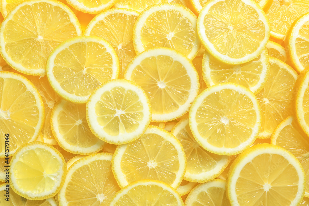 Many fresh juicy lemon slices as background, top view