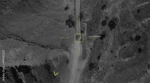 Aerial view of a military drone takes aim at a tank and shoots at it