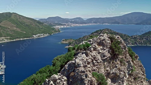 Flying over a cliff in the Turkish bay of Marmaris overlooking the island and the city