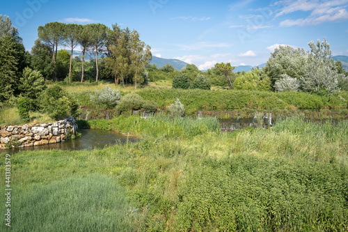 Dam, river and small waterfalls near a road in province of Fronzinone in Italy photo