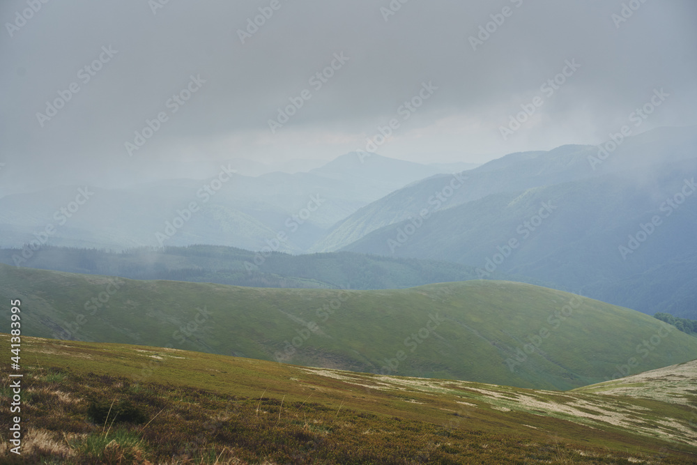 Low clouds and fog over the mountains. Svidovets ridge. Ukraine, Carpathian mountains.