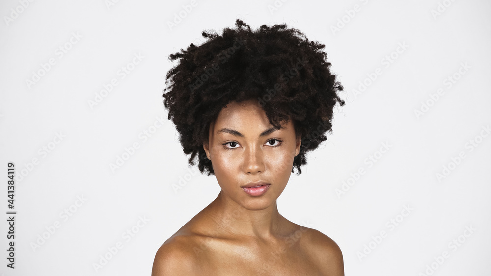 African american woman with perfect skin looking at camera isolated on grey