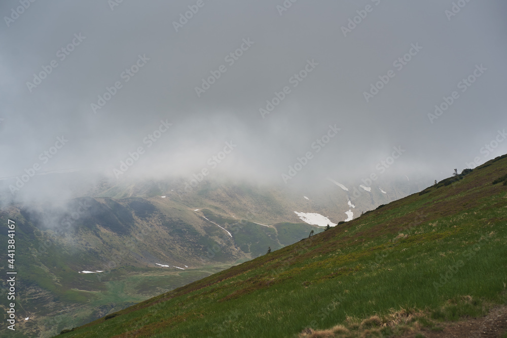 Low clouds and fog over the mountains. Svidovets ridge. Ukraine, Carpathian mountains. Low clouds and fog over the mountains. Svidovets ridge. Ukraine, Carpathian mountains.