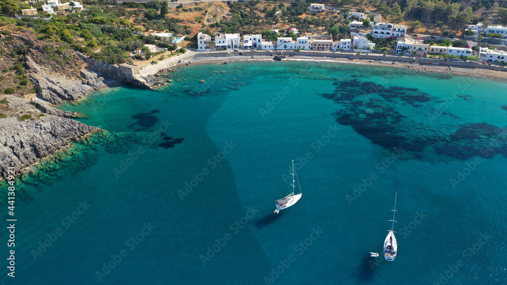 Aerial drone photo of beautiful twin bay, beach and small village of Kapsali  below iconic castle of Kythera island, Ionian, Greece