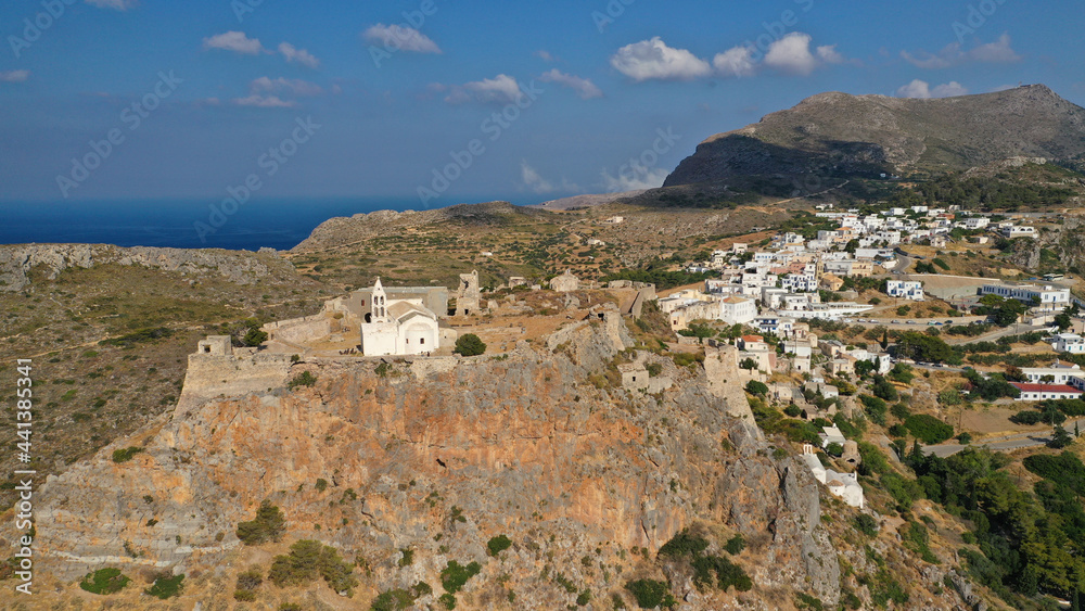Aerial drone photo above iconic medieval castle and main village of Kithira island overlooking beautiful double bay and beach of Kapsali, Kythira island, Ionian, Greece