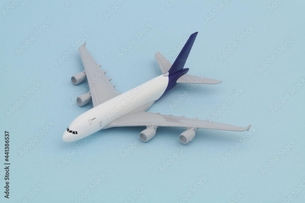 Airplane model on blue background. Travel concept. Airplane model on blue background. Travel concept.
