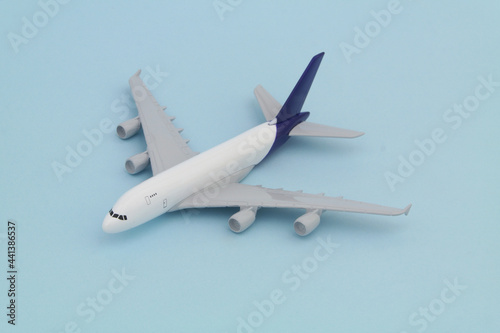 Airplane model on blue background. Travel concept. 