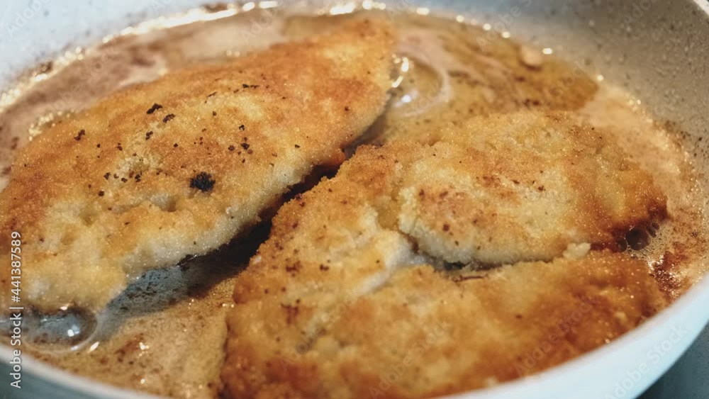 Preparation of marinated chicken breast in breadcrumbs in a frying pan in olive oil. Cook's preparation of chicken and chicken fillet. Preparation of marinated chicken breast in breadcrumbs in a frying pan in olive oil. Cook's preparation of chicken and chicken fillet.