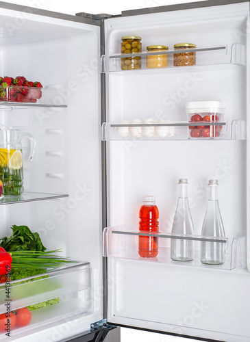 Open fridge full of fresh fruits and vegetables