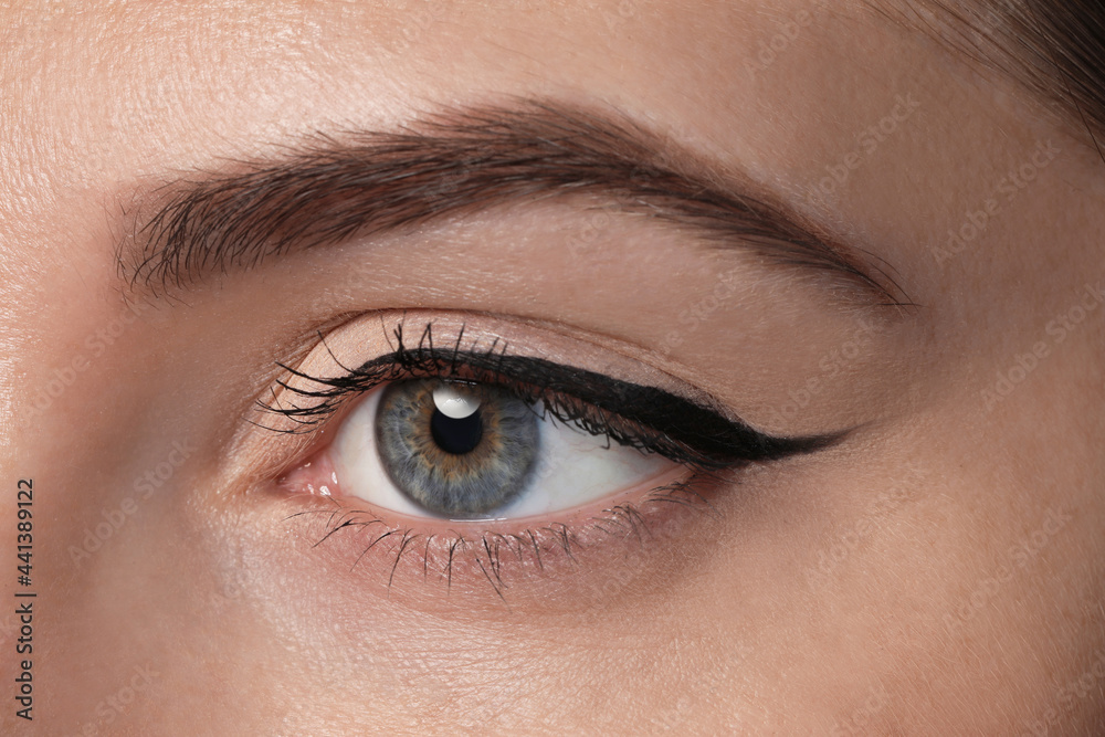 Obraz premium Beautiful woman with black eyeliner, closeup view