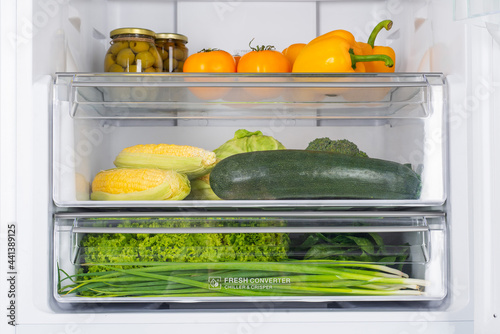 Open fridge full of fresh fruits and vegetables
