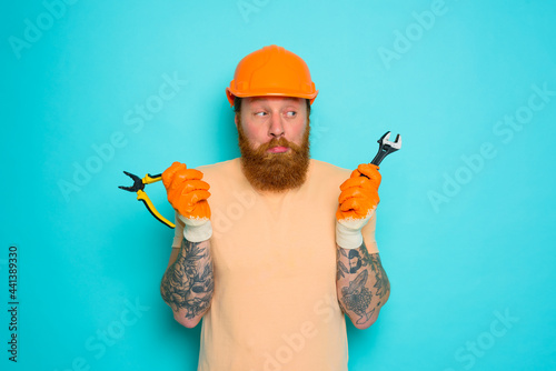 Worker with yellow hat is confused about his work photo