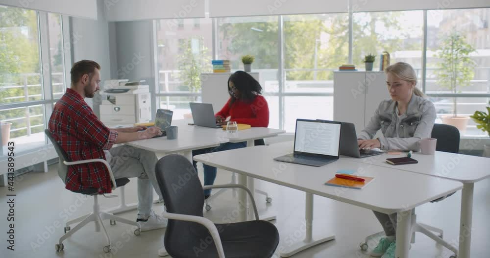 Group of diverse students or employees using laptop studying and working at open space office Group of diverse students or employees using laptop studying and working at open space office