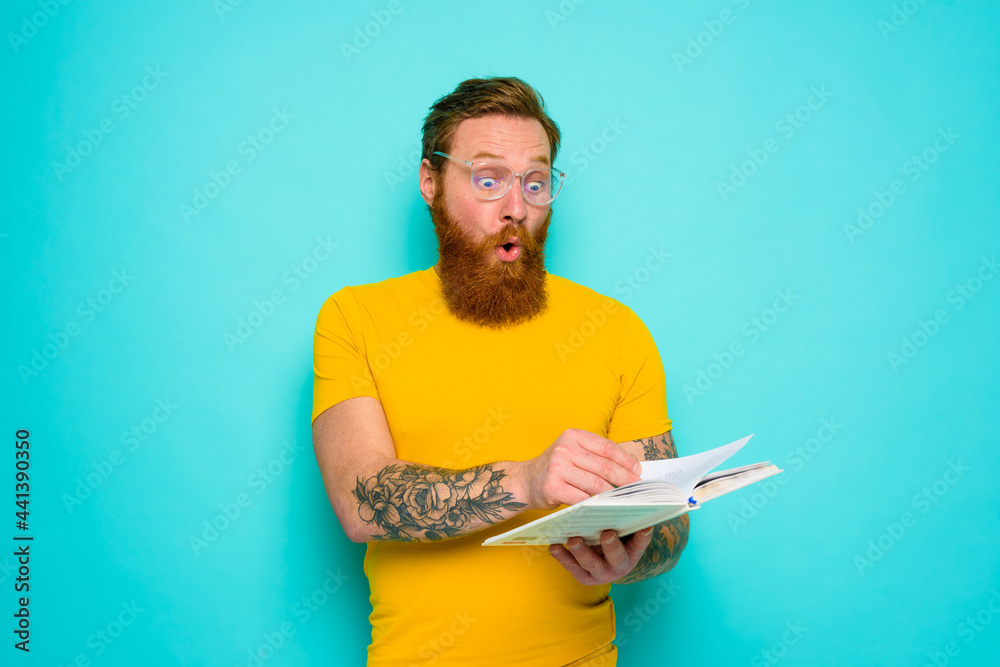 Man with yellow t-shirt and beard is surprised about something Man with yellow t-shirt and beard is surprised about something