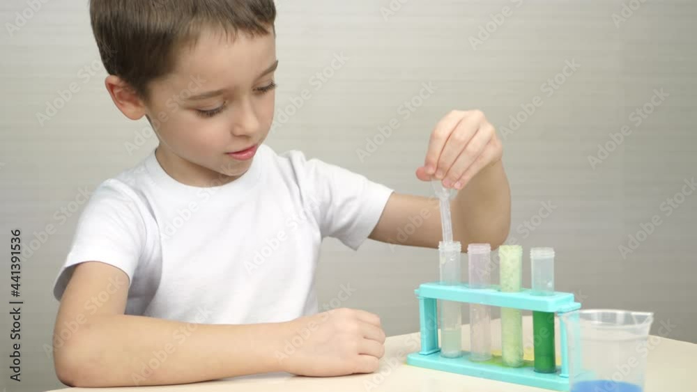 A happy child learns the reactions of chemicals. Laboratory. The future of biochemistry. Distance education. Laboratory assistant. Researches. Scientific discoveries A happy child learns the reactions of chemicals. Laboratory. The future of biochemistry. Distance education. Laboratory assistant. Researches. Scientific discoveries