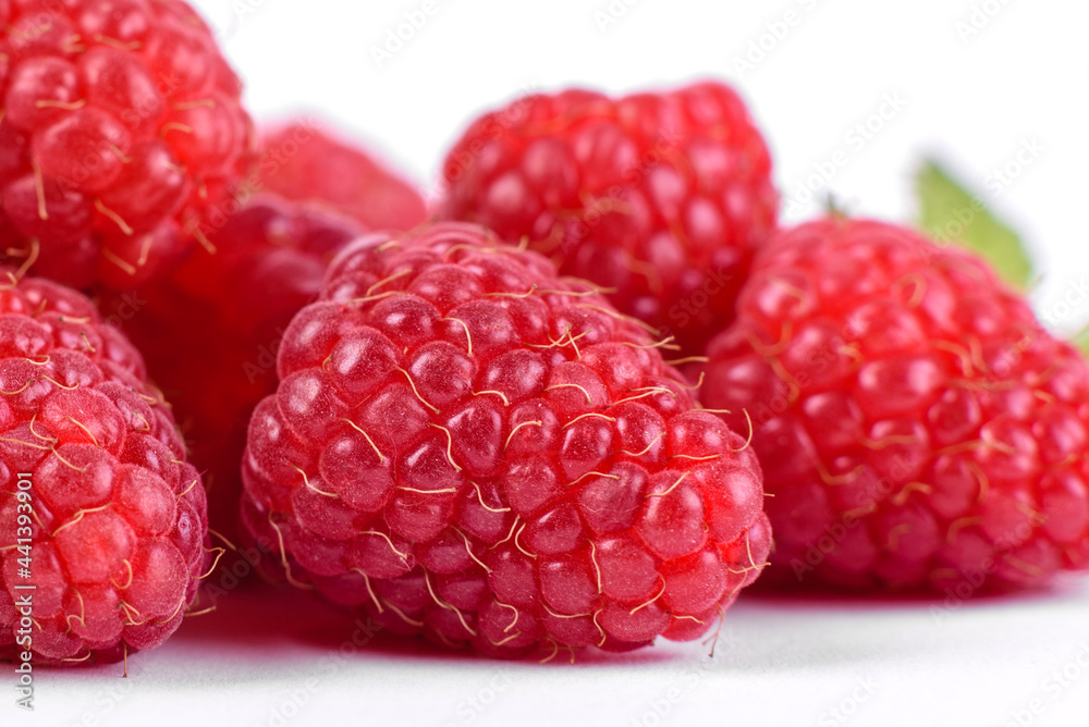 Ripe raspberries with raspberry leaf isolated on a white background