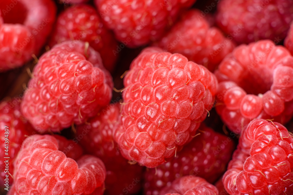 Delicious fresh juicy red raspberries on a dark table Delicious fresh juicy red raspberries on a dark table
