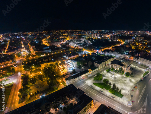 Night lights illuminated aerial panorama view. City center square (Maidan Konstytutsii) with Holy Annunciation Cathedral, historical museum , Svyato-Pokrovskyy Monastyr landmarks in Kharkiv, Ukraine photo