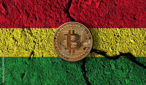 Bitcoin crypto currency coin with cracked Bolivia flag. Crypto restrictions photo