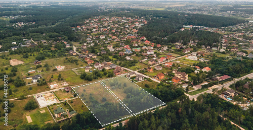 Marked vacant land for construction and sale. The concept of selling land and residential real estate on the land market is an aerial shot with overlay. photo