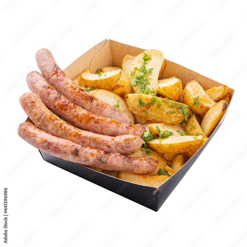 Grilled sausages and fries in a cardboard craft box, angle view, isolated on white background. Fast food set.