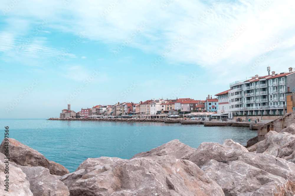 A panoramic of old historical Adriatic city of Piran, Slovenia. View over the tiled roofs of Piran and the Adriatic Sea.